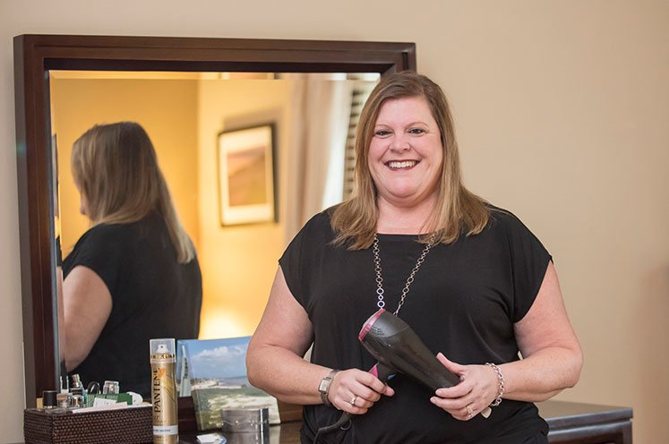 breast cancer patient laura styling her hair after using cool cap technology