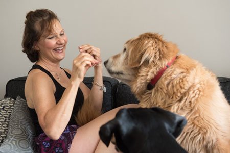 breast cancer patient lynn walkuski feeding her dogs