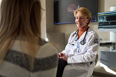 A Henry Ford Health cancer physician sees patient for cancer symptom care at the OncoStat Same-Day Symptom Care Clinic in Detroit, MI