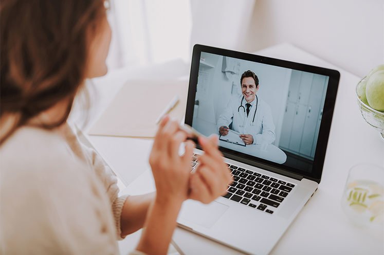 Patient talking to her doctor on laptop