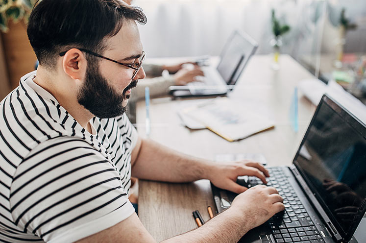 man working on a laptop computer
