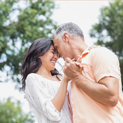 Smiling couple dancing outside