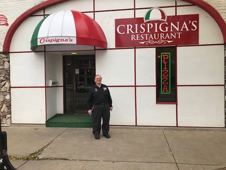 kidney cancer patient Joe in front of his restaurant