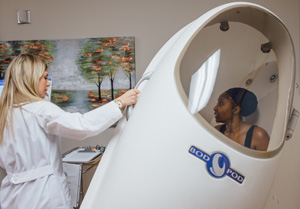 doctor helping patient into Bod Pod