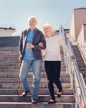 senior couple walking down the stairs
