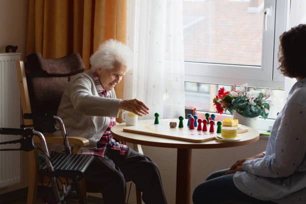 Woman and caregiver playing chess game