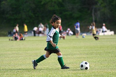 little girl playing soccer