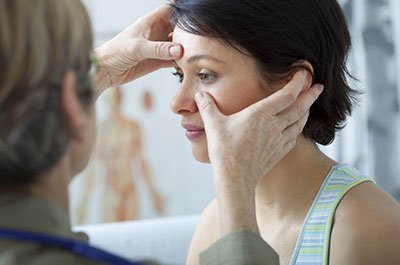 female patient getting a facial exam