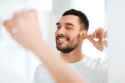 man cleaning his ears