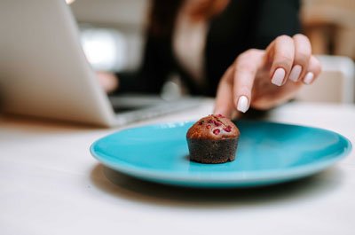 hand reaching for mini muffin