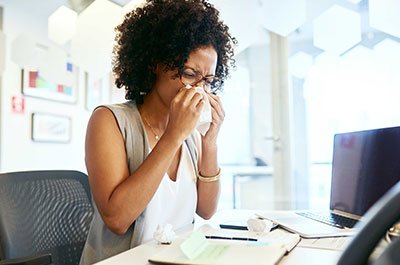 woman blowing her nose