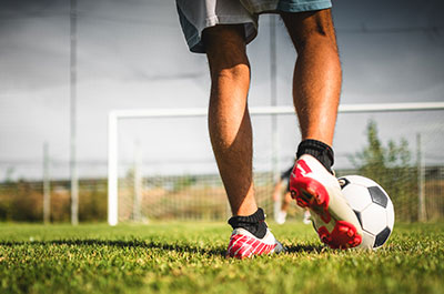 soccer player kicking ball