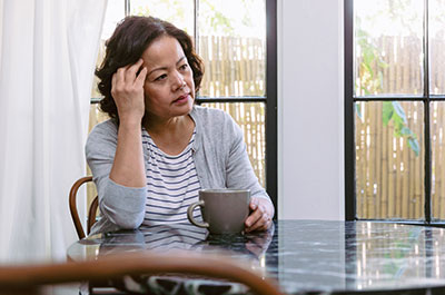 elderly woman sitting at table