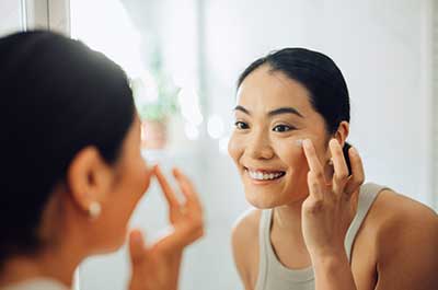 woman applying skincare product