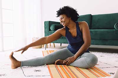 woman stretching at home