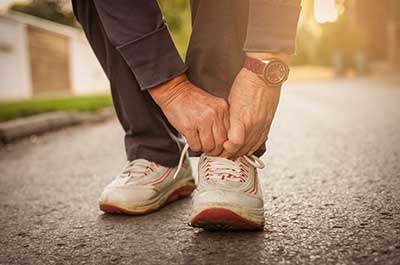 man tying shoe laces
