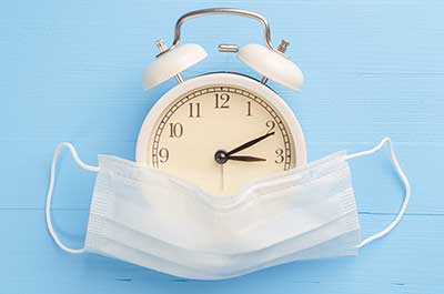 mask and clock concept blue background