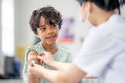 doctor giving child vaccine