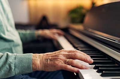 older man playing the piano