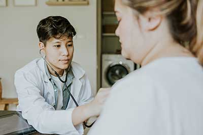 doctor checking patients heart beat