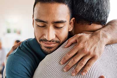 dad hugging son