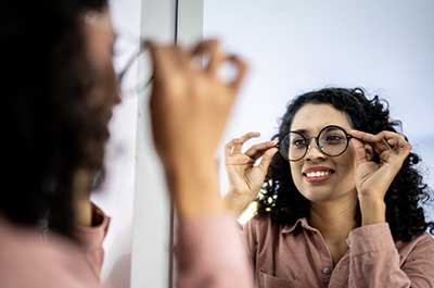 woman trying on glasses