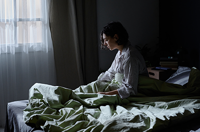 woman sitting up in bed