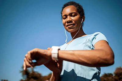 woman checking heart rate on smart watch
