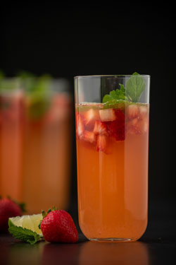 Tall glass with a strawberry mojito mocktail