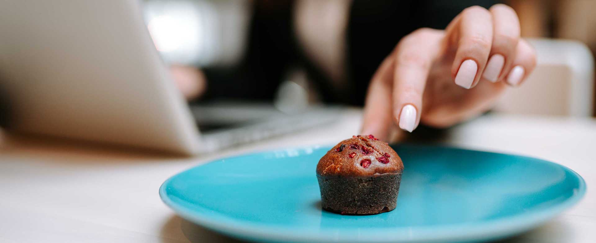 hand reaching for mini muffin