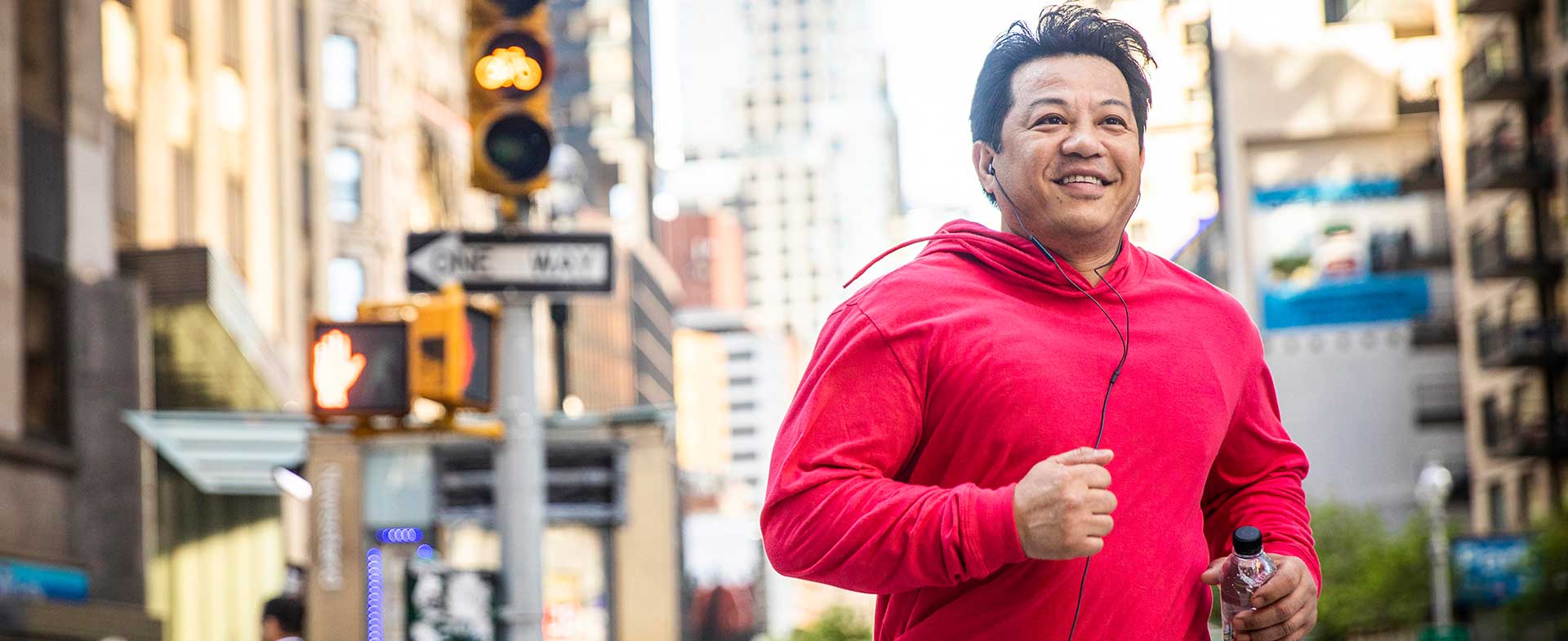 man running on city street