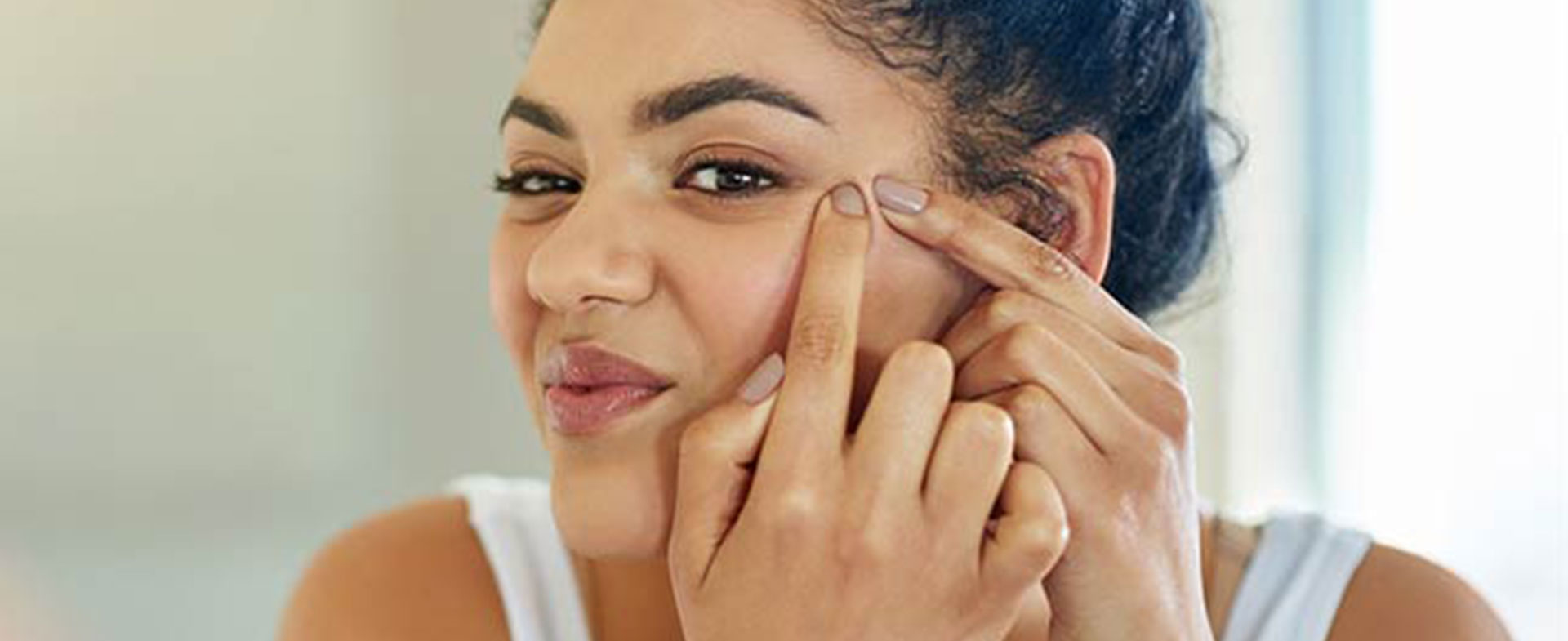 woman looking in mirror