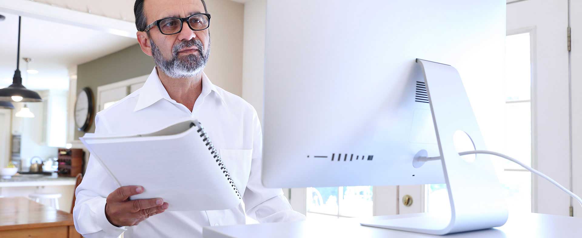 man working at standing desk