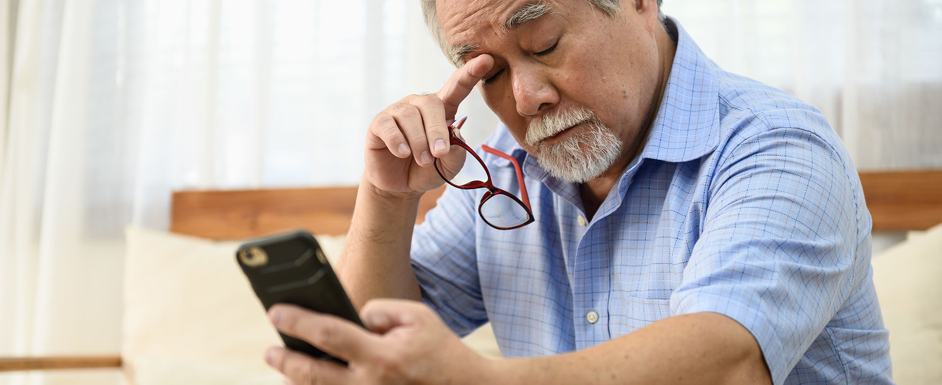 man trying to read phone