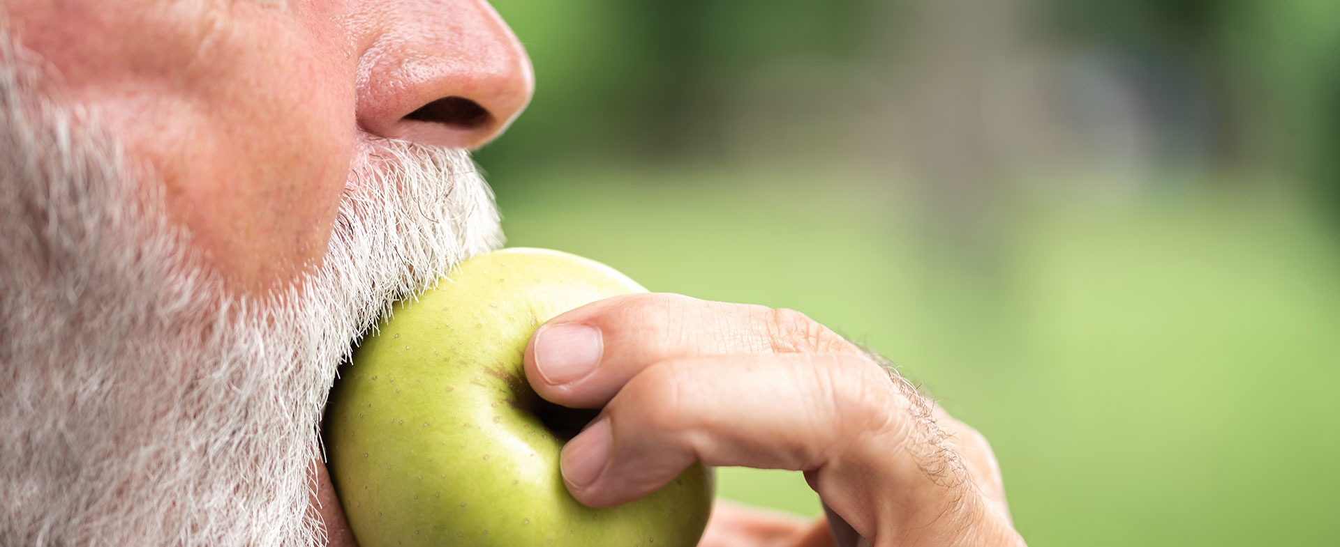 old man eating apple