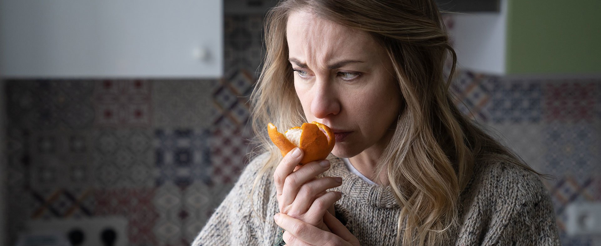 woman smelling orange