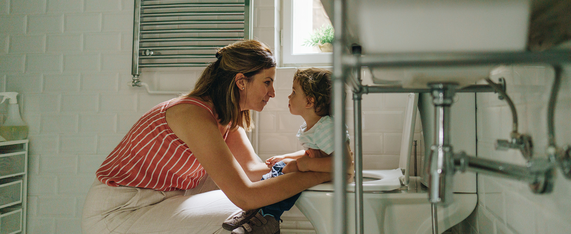 child with mom on toilet