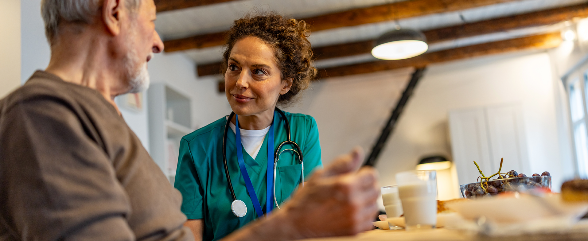 older man talking to medical professional