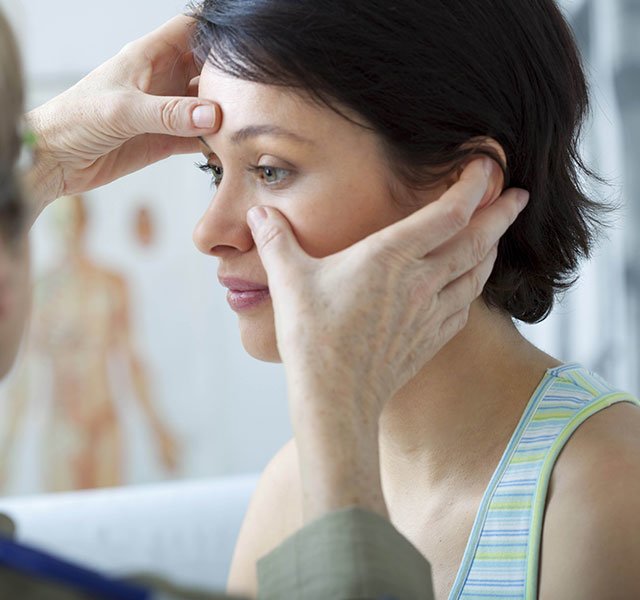 female patient getting a facial exam