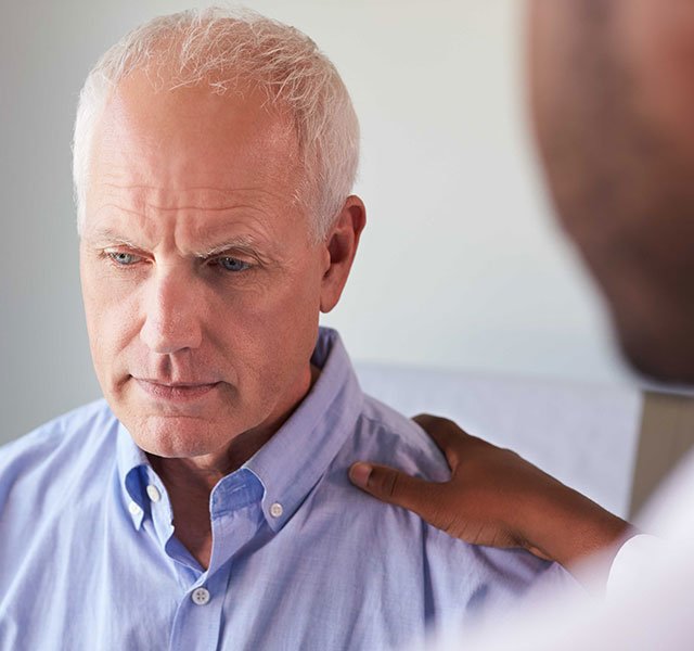 older man sitting in a doctors office