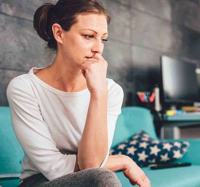 woman sitting looking worried