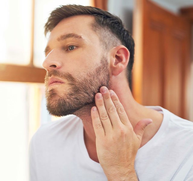 man touching his beard