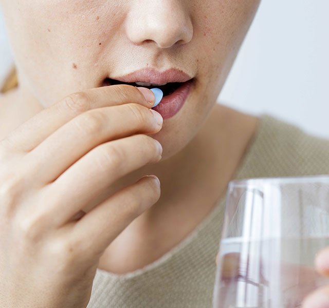 woman taking a pill