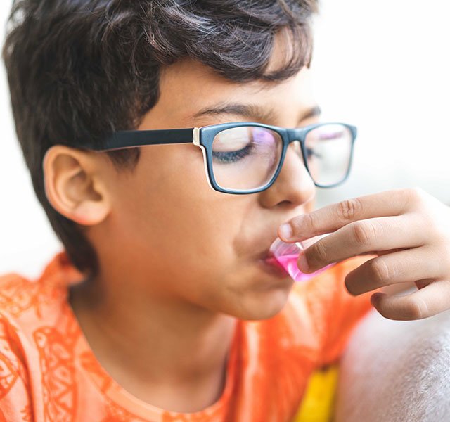 boy taking medicine