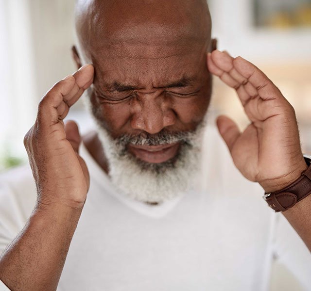 Man rubbing the sides of his head