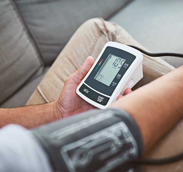 Man taking blood pressure at home