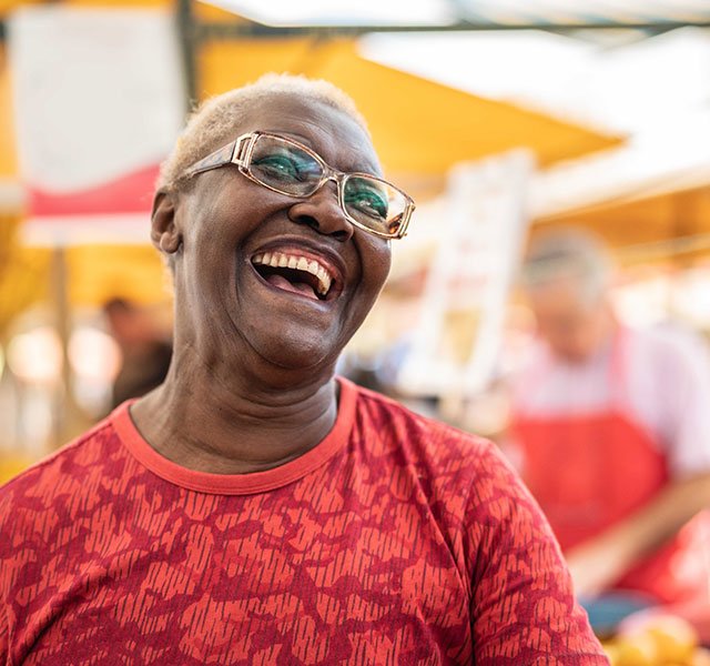 older woman in red laughing