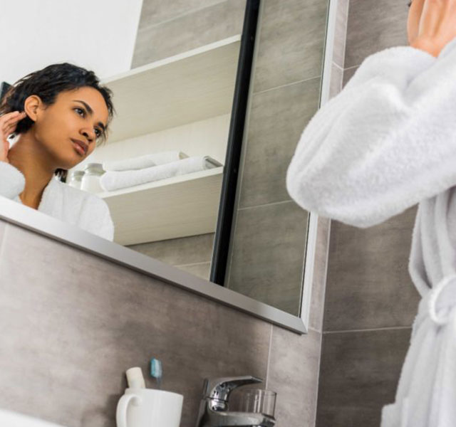 woman looking in the mirror