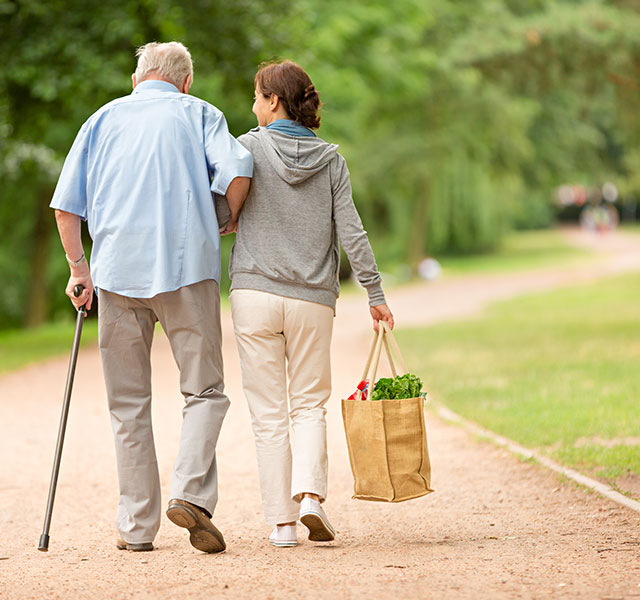 woman helping man with groceries