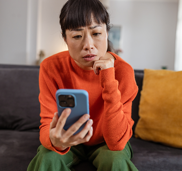 worried woman looking at phone